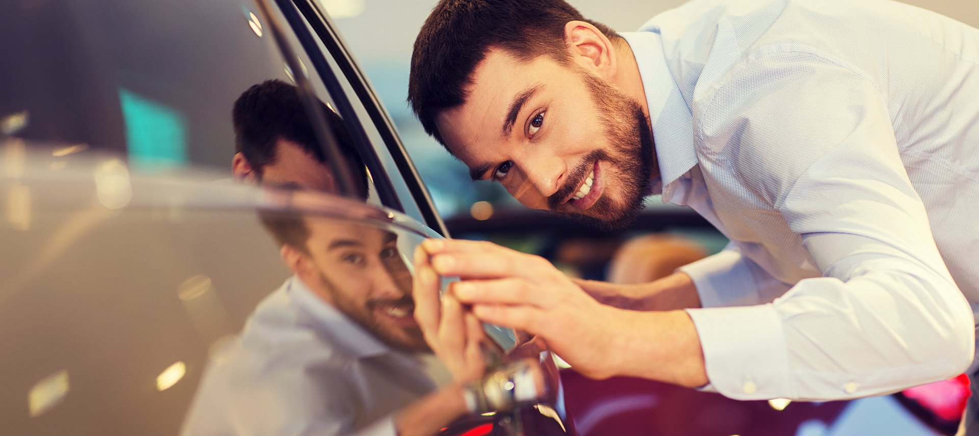 Man enjoying reflection in car