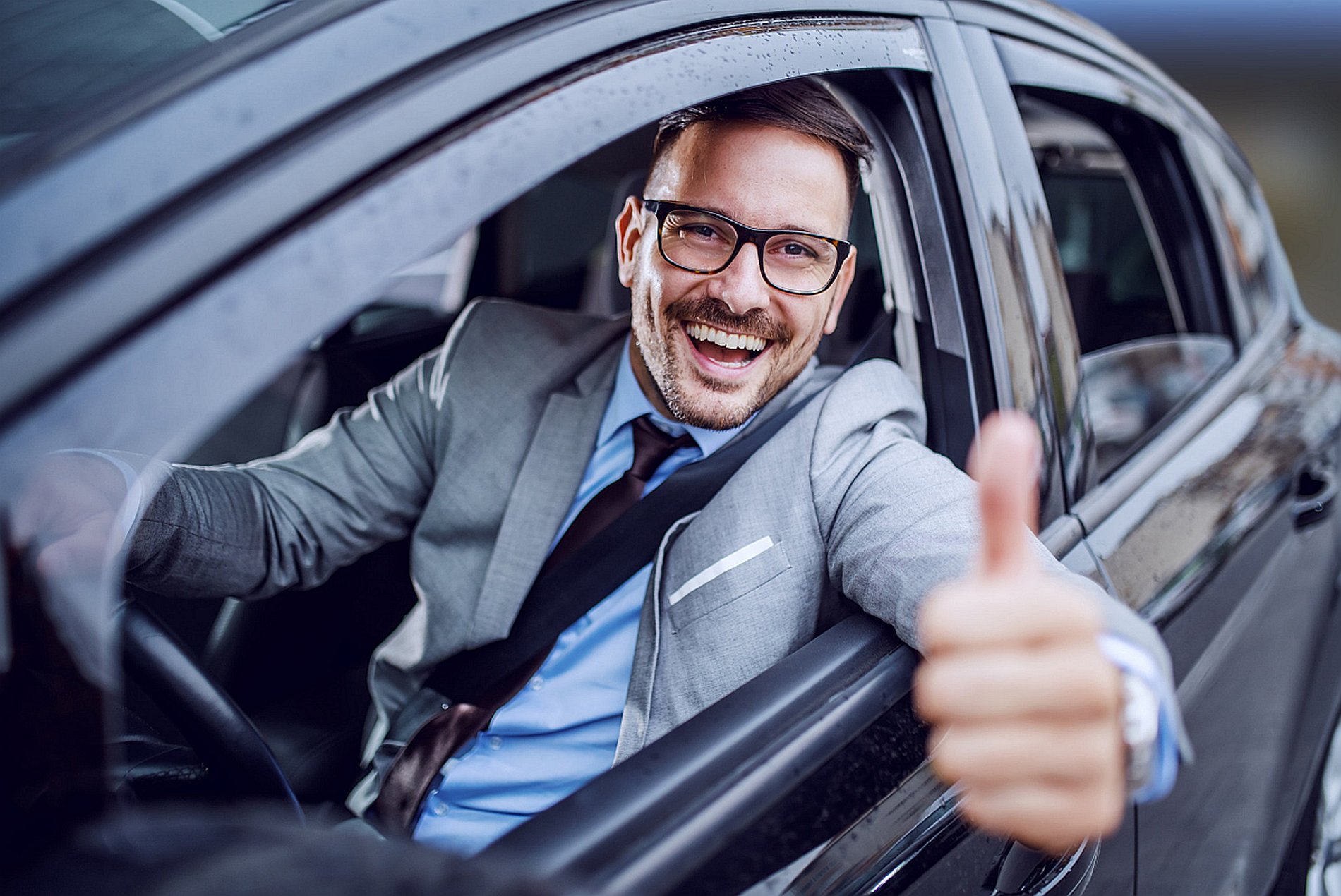 Man Leaving Wash, smiling and thumbs up as he goes